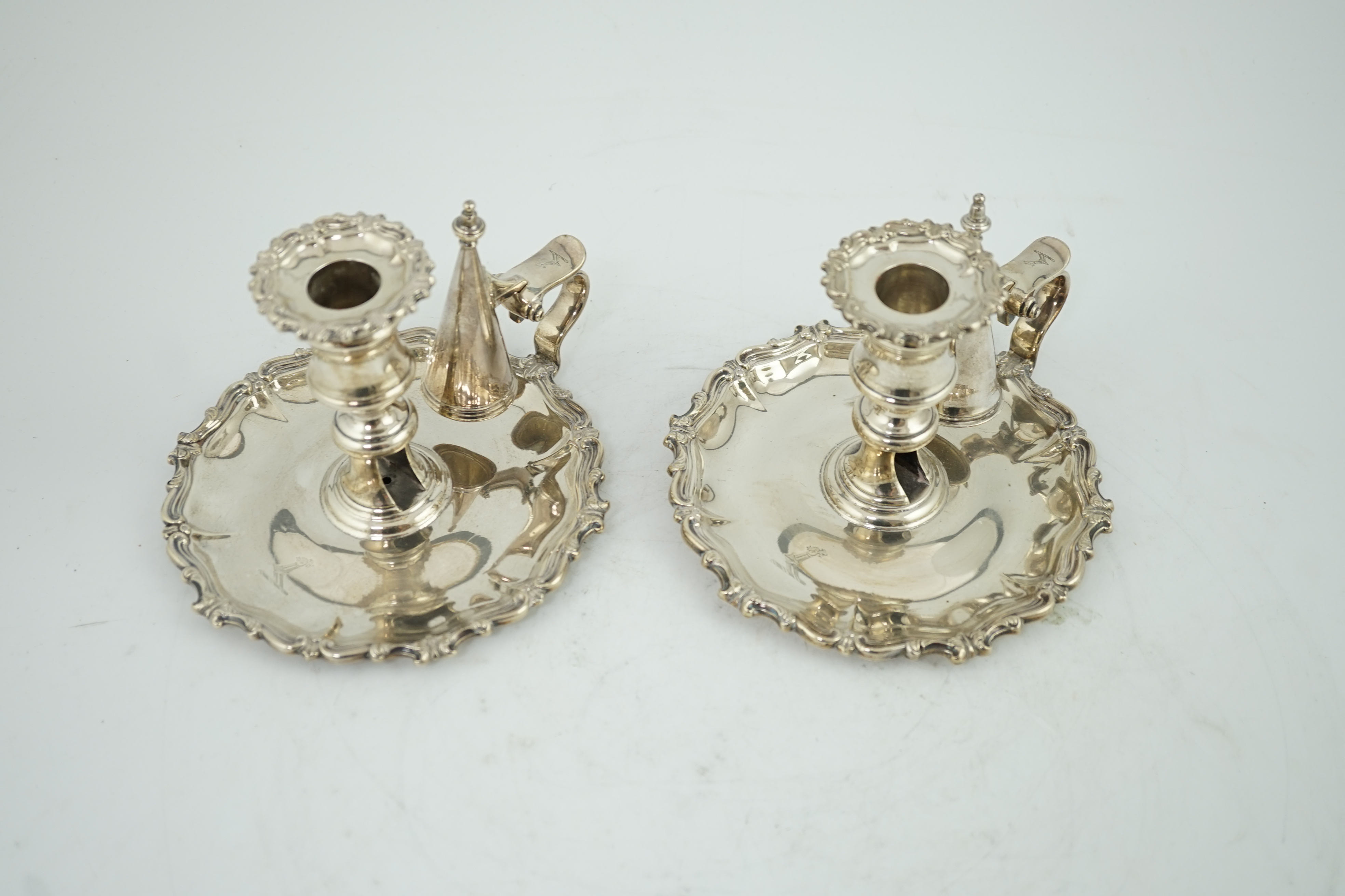 A pair of William IV silver chambersticks and extinguishers, by Creswick & Co